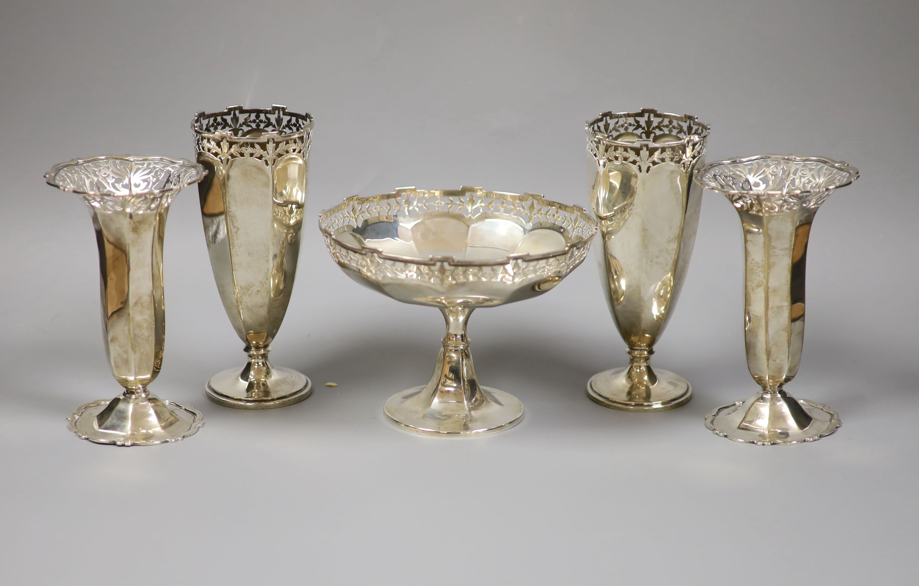 Two pairs Edwardian silver posy vases, London, 1901 and 1904, Goldsmiths & Silversmiths Co Ltd, together with a George V small pedestal bowl, Birmingham 1924 (mark rubbed) (5) total weight 24.0 ozt.